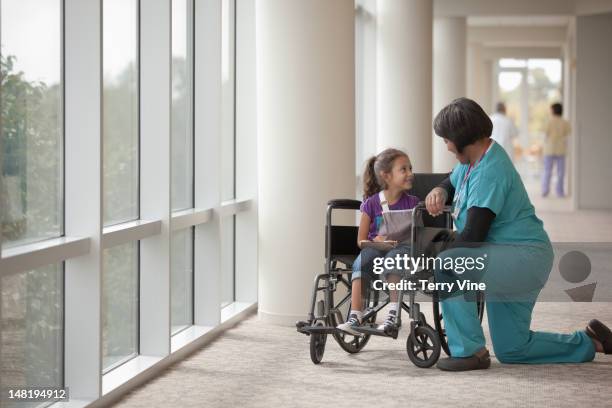 nurse talking to girl in wheelchair - nurse wound stock pictures, royalty-free photos & images