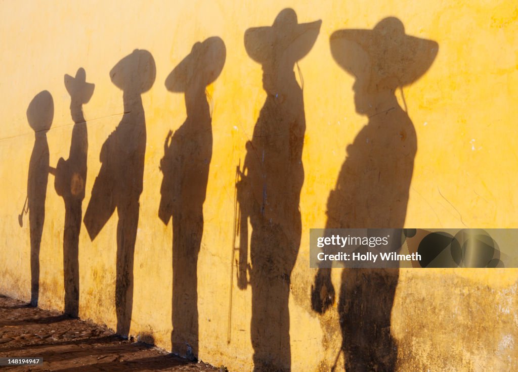 Shadows of mariachi band members