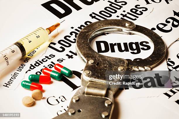 handcuff, jeringa de cápsulas, de sobres & en titulares del fármaco - dispositivo de control fotografías e imágenes de stock