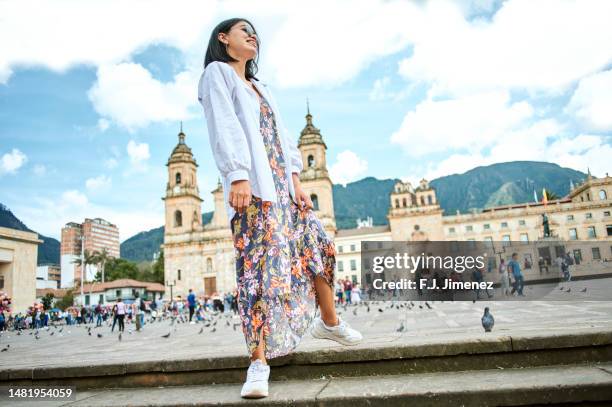 woman walking in bolivar square in bogota - bolivar square bogota stockfoto's en -beelden