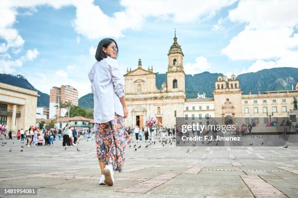 woman walking in bolivar square in bogota - bogota stock pictures, royalty-free photos & images