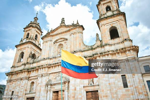 colombian flag and the cathedral of bogota - bolivar square bogota stock-fotos und bilder