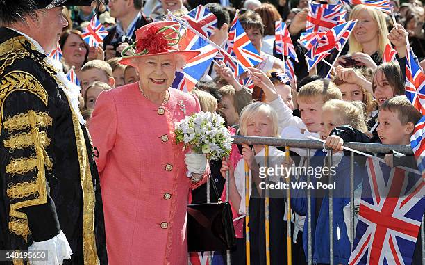 Queen Elizabeth II greets schoolchildren in Victoria Square during her Diamond Jubilee visit to the City on July 12, 2012 in Birmingham, England....