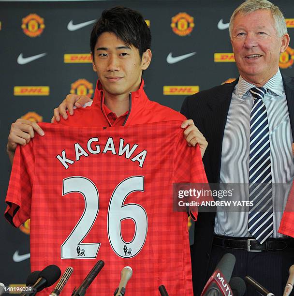 Manchester United's new signing Japanese midfielder Shinji Kagawa attends a press conference with Manchester United manager Alex Ferguson at Old...