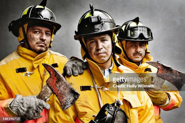firefighters in protective clothing - helden stock-fotos und bilder