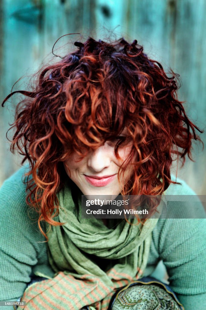 Smiling woman with curly red hair