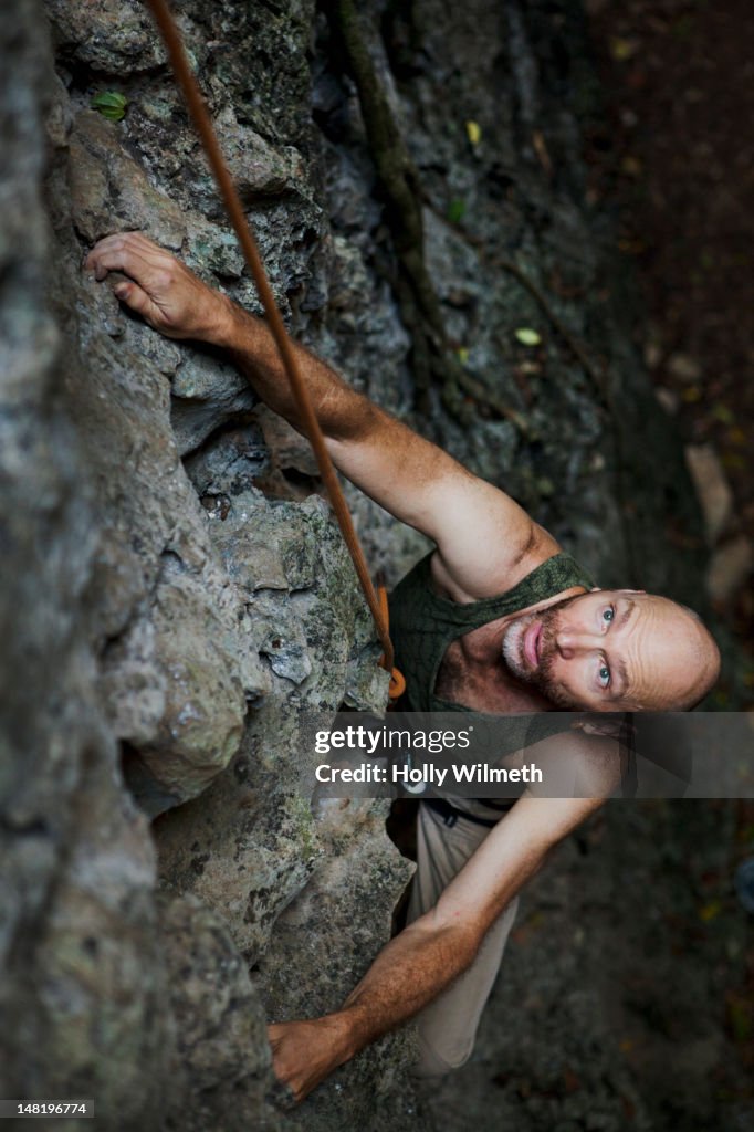 Rock climber climbing rock wall