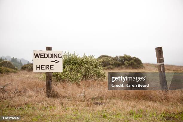 post in field with sign - wedding here - rural scene wedding stock pictures, royalty-free photos & images