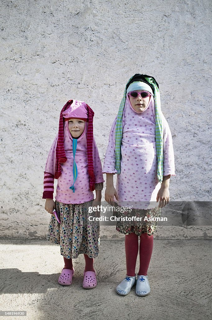 Children playing dress up outdoors