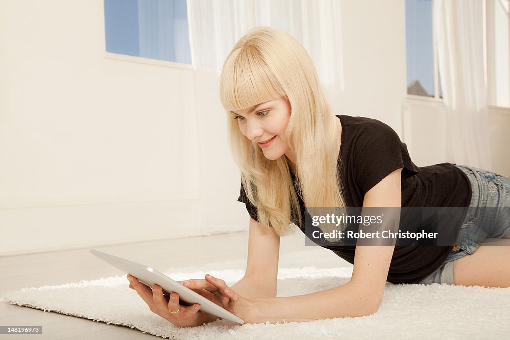 Smiling woman using tablet computer