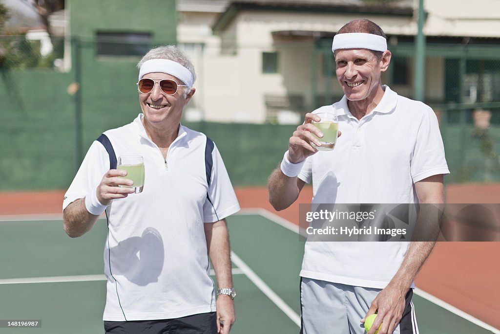 Older men drinking lemonade on court