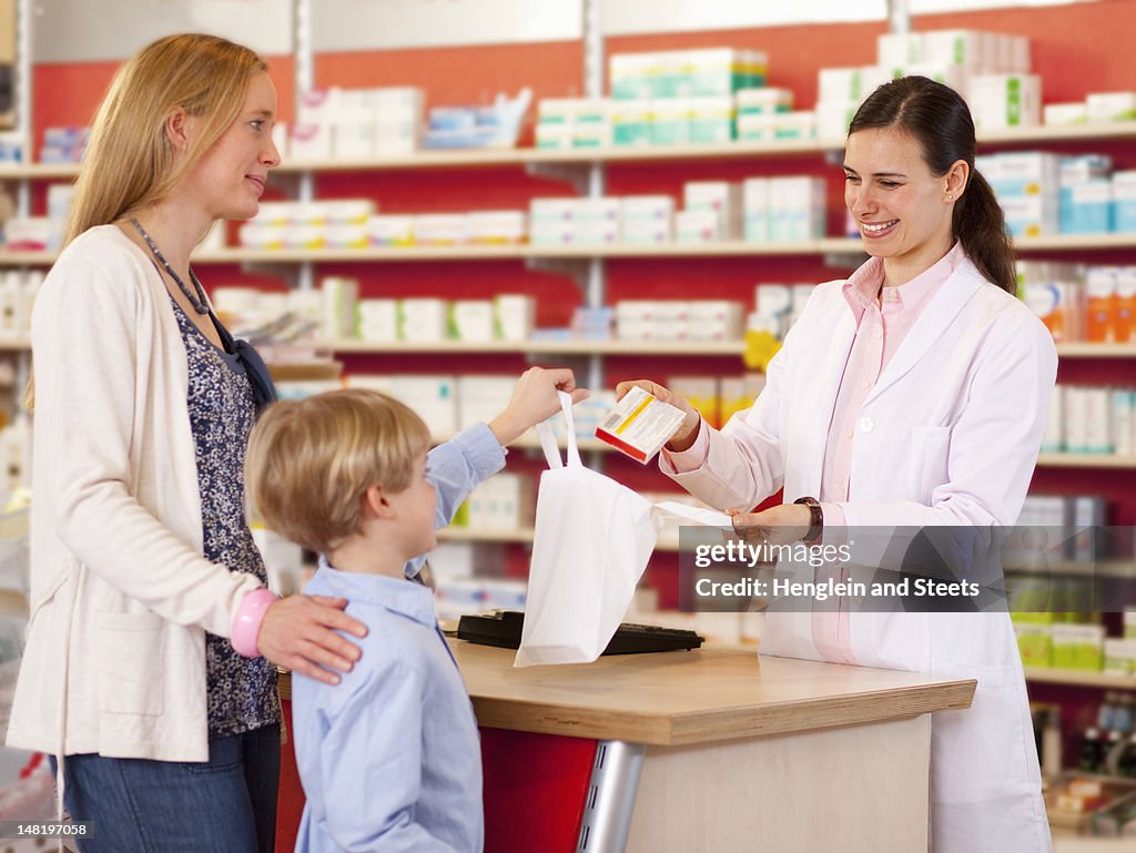 Pharmacist filling prescription in store