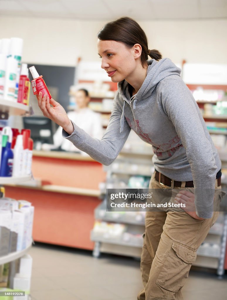 Customer browsing on drugstore shelves