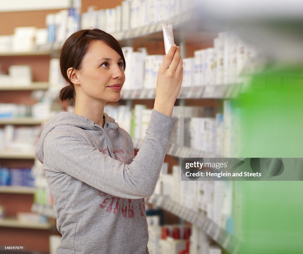 Customer browsing on drugstore shelves