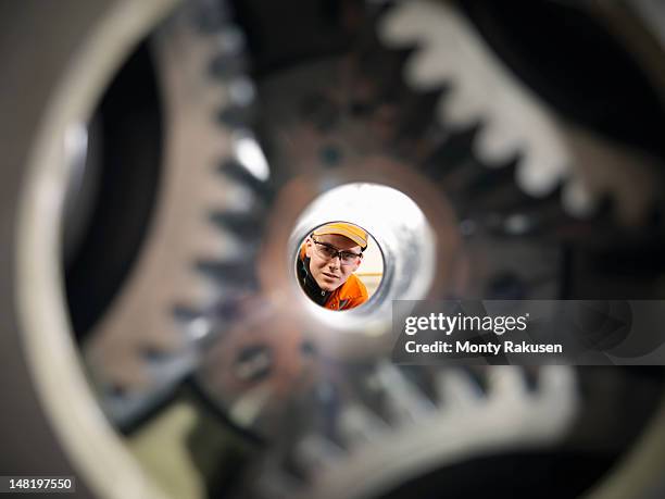 apprentice engineer looking through gear box - manufacturing machinery close up stock pictures, royalty-free photos & images