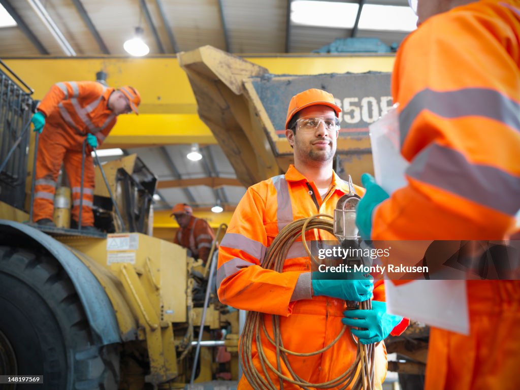 Apprentice engineer and engineers in discussion