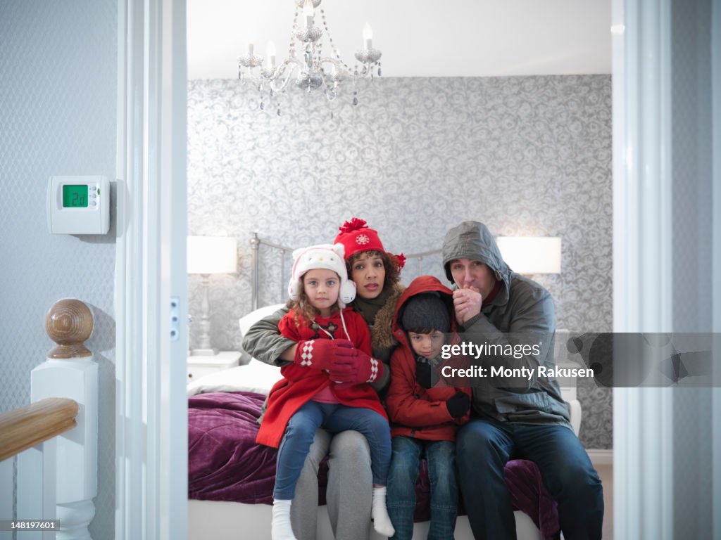 Family wearing winter clothing in bedroom of energy efficient house