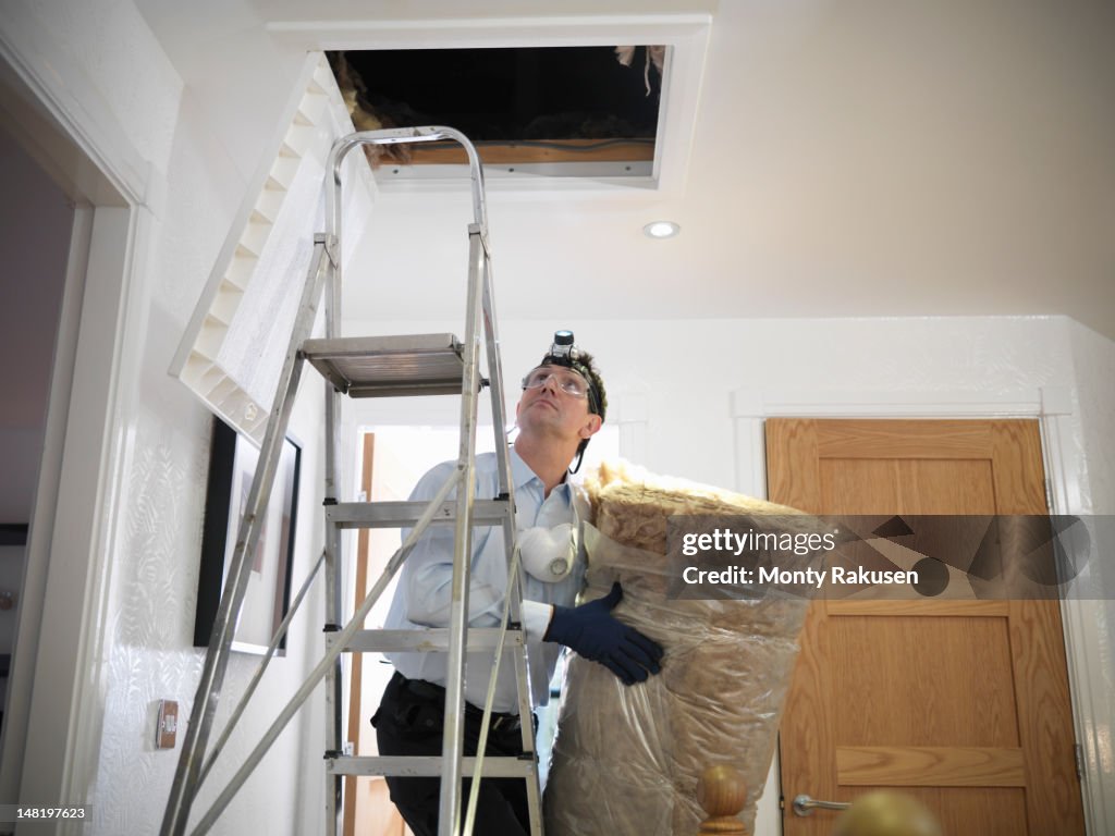 Man preparing to insulate loft in house