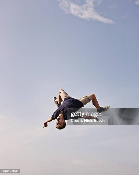 teenage boy posing in mid-air - person falling mid air stock pictures, royalty-free photos & images