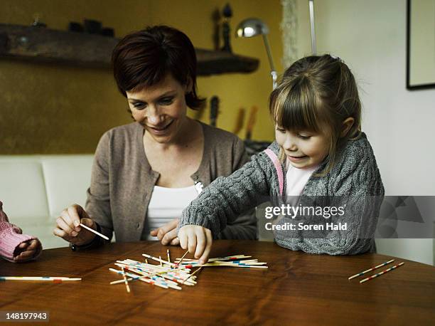 Mother and daughters playing together