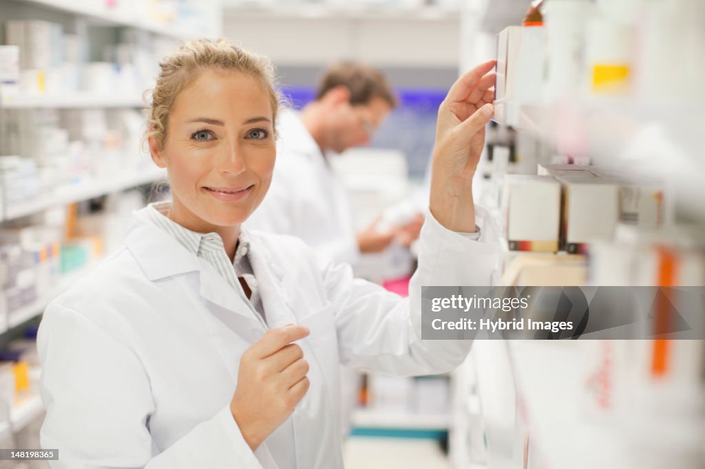 Pharmacists browsing medicines on shelf