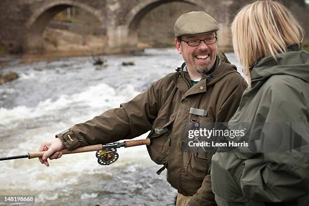 couple fishing for salmon in river - scottish borders stock pictures, royalty-free photos & images