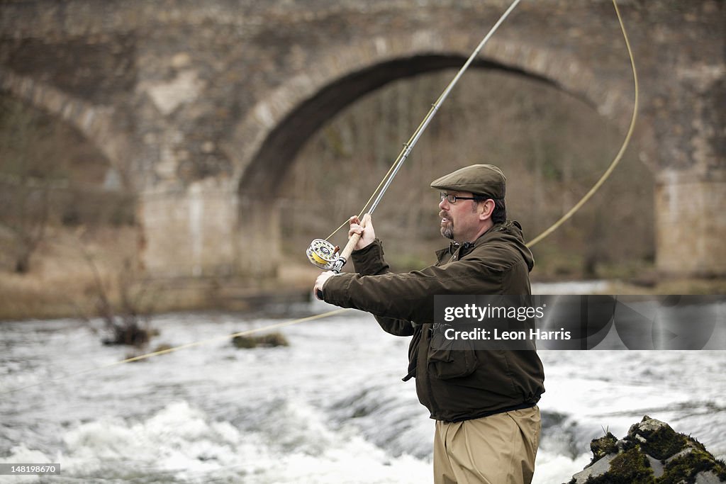 Man fishing for salmon in river