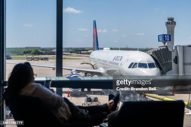 Passenger waits near a Delta Air lines terminal in the Austin-Bergstrom International Airport on April 13, 2023 in Austin, Texas. Delta Air Lines...