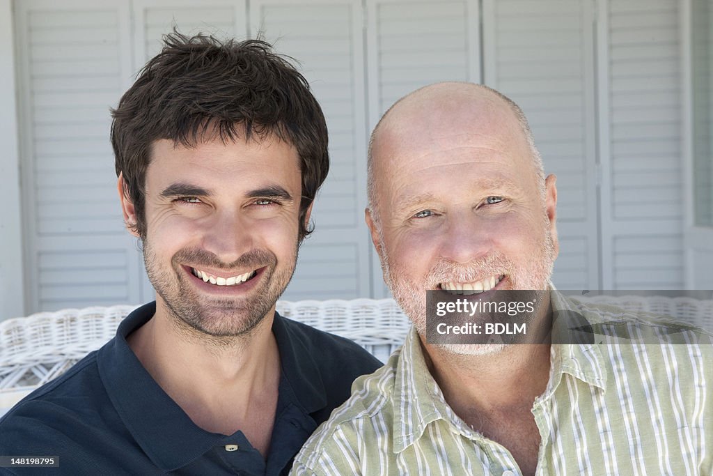 Father and son sitting on sofa