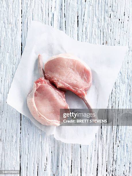 raw pork chop in butcher paper - butcher paper on white stock pictures, royalty-free photos & images