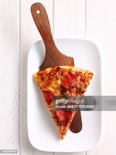 slice of pizza on platter - pizza slice stock pictures, royalty-free photos & images