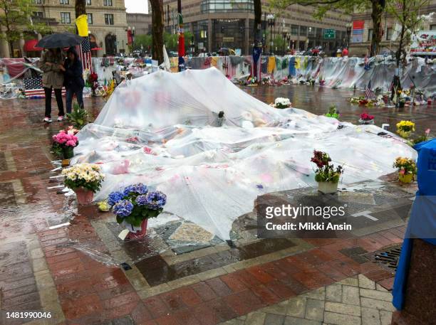 View of a partially enclosed, plastic-covered memorial to victims of the Boston Marathon Bombing , Copley Square, Boston, Massachusetts, May 9, 2013.