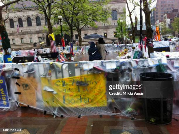 View of a partially enclosed, plastic-covered memorial to victims of the Boston Marathon Bombing , Copley Square, Boston, Massachusetts, May 9, 2013....