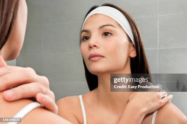 woman examining herself in mirror - headband stock pictures, royalty-free photos & images
