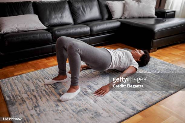 woman practicing yoga, glute bridge exercise, dvi pada pithasana pose - serbia bridge stock pictures, royalty-free photos & images