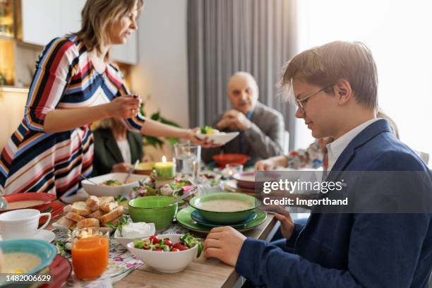 multi generation family sitting at the table for traditional easter breakfast - easter breakfast stock pictures, royalty-free photos & images