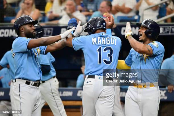 Randy Arozarena, Manuel Margot, and Wander Franco of the Tampa Bay Rays react after scoring in the fifth inning against the Boston Red Sox at...