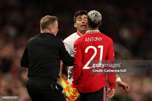 Antony of Manchester United clashes with Marcos Acuna of Sevilla FC during the UEFA Europa League quarterfinal first leg match between Manchester...
