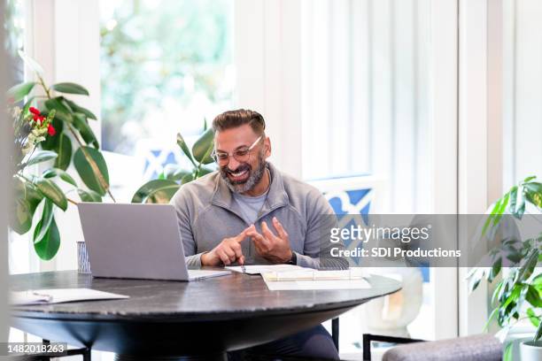 mature male professor teaches online college class from home - virtual event space stock pictures, royalty-free photos & images