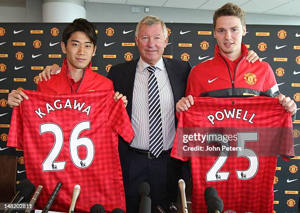 Manager Sir Alex Ferguson of Manchester United poses with new signings Shinji Kagawa and Nick Powell during a press conference at Old Trafford on...