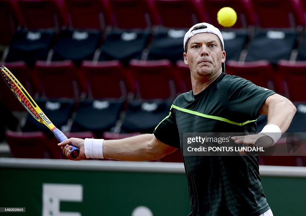 Kazakhstan's Evgeny Korolev returns a sh