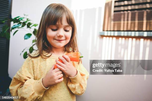 cute preschool girl holding pepper vegetable in her hands, - bell pepper stock pictures, royalty-free photos & images