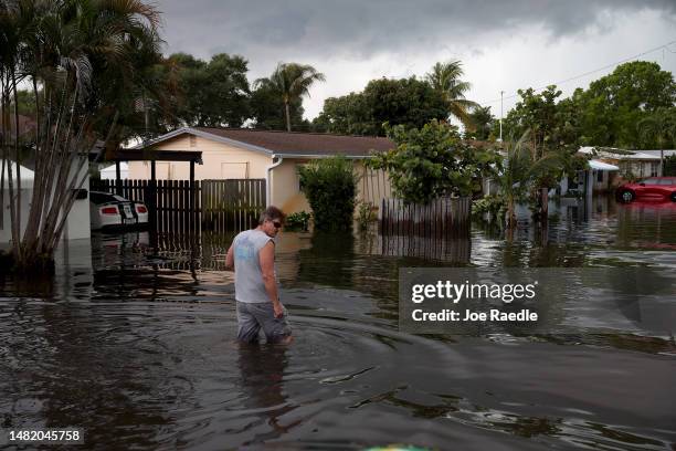 Person walks through a flooded street on April 13, 2023 in Fort Lauderdale, Florida. Nearly 26 inches of rain fell on Fort Lauderdale over a 24-hour...
