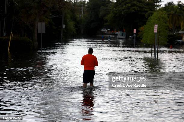 Person walks through a flooded street on April 13, 2023 in Fort Lauderdale, Florida. Nearly 26 inches of rain fell on Fort Lauderdale over a 24-hour...