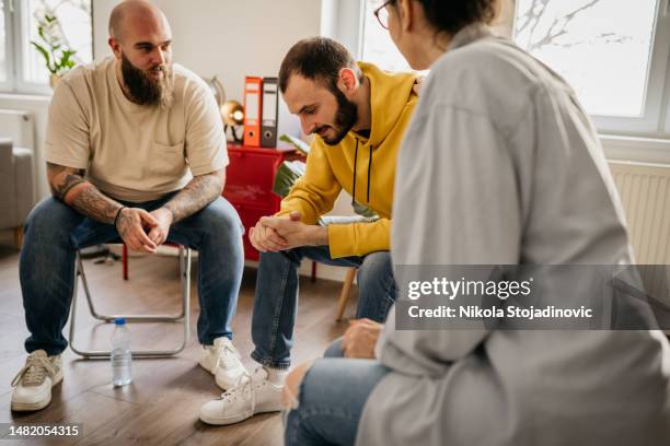 resolving problems on a group therapy - addiction stock pictures, royalty-free photos & images