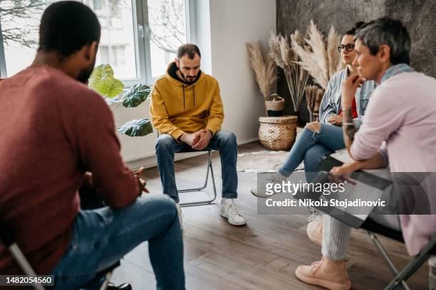 multiracial group of people having a psychotherapy - drug rehab stock pictures, royalty-free photos & images