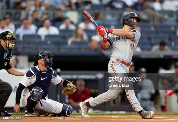 Edouard Julien of the Minnesota Twins gets his first major league hit as Kyle Higashioka of the New York Yankees defends in the first inning at...