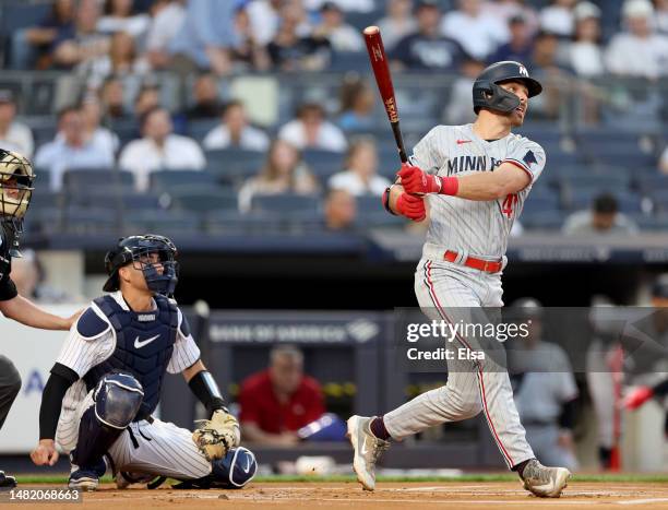 Edouard Julien of the Minnesota Twins gets his first major league hit as Kyle Higashioka of the New York Yankees defends in the first inning at...