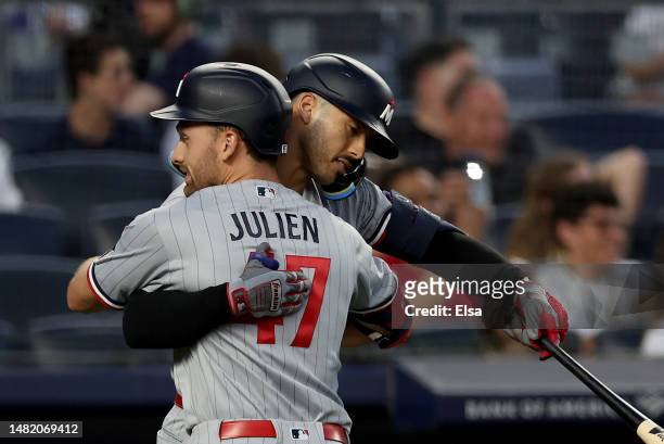 Edouard Julien of the Minnesota Twins is congratulated by teammates Carlos Correa after Julien hit a solo home run in the first inning against the...