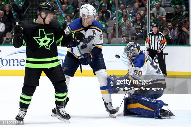 Jordan Binnington of the St. Louis Blues blocks a shot on goal against Max Domi of the Dallas Stars as Colton Parayko of the St. Louis Blues in the...